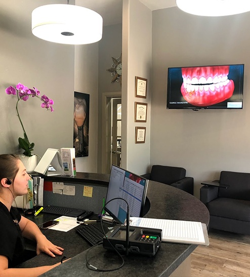 Team member behind reception desk