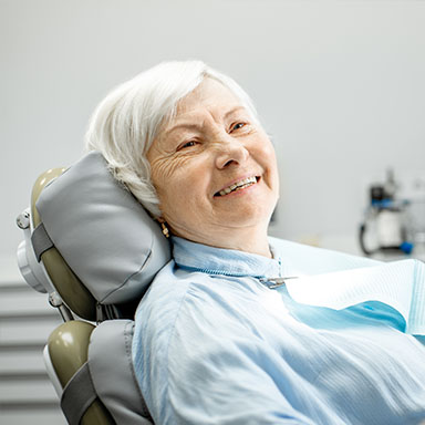 Smiling older woman in dental chair