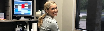 Smiling team member behind reception desk