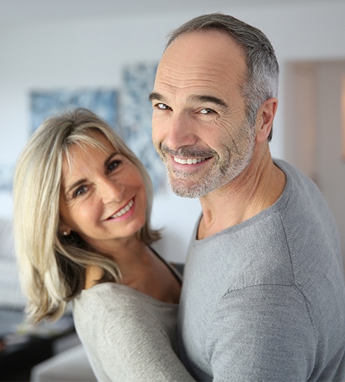 Smiling older man and woman dancing together