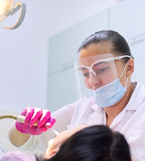 sedation dentist in Horseshoe Bay cleaning a patient’s teeth