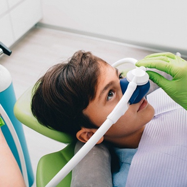 child with a small nose mask on at the dentist’s office