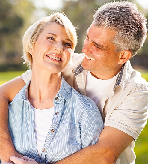 Smiling older man and woman outdoors