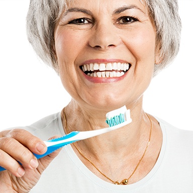 Older woman brushing teeth