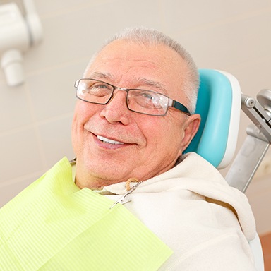 Smiling older man in dental chair
