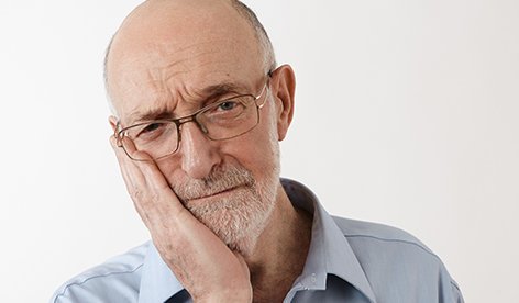 Man holding jaw in pain