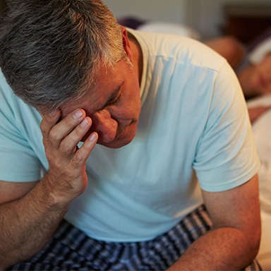 Tired frustrated man with head in hands