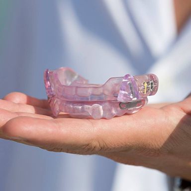 Hand holding an oral appliance