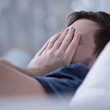 Frustrated man covering face with hands