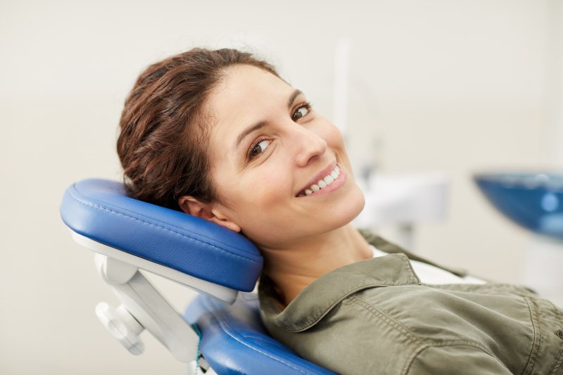 a young woman smiling in the dentist’s chair