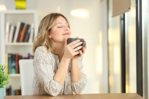 woman enjoys cavity-fighting beverage as recommended by dentist near Marble Falls